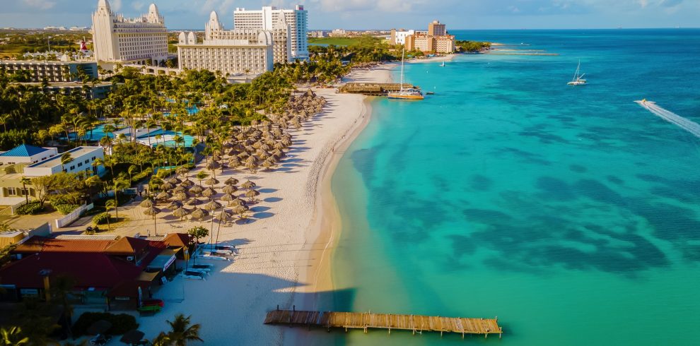 Palm beach Aruba Caribbean, white long sandy beach with palm trees at Aruba